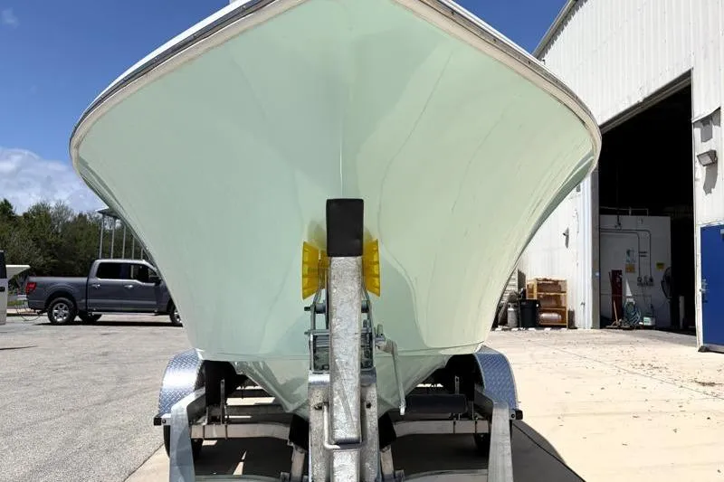 Slide: The Image of 2024 Key West 203 FS boat on trailer outside a warehouse. - 9