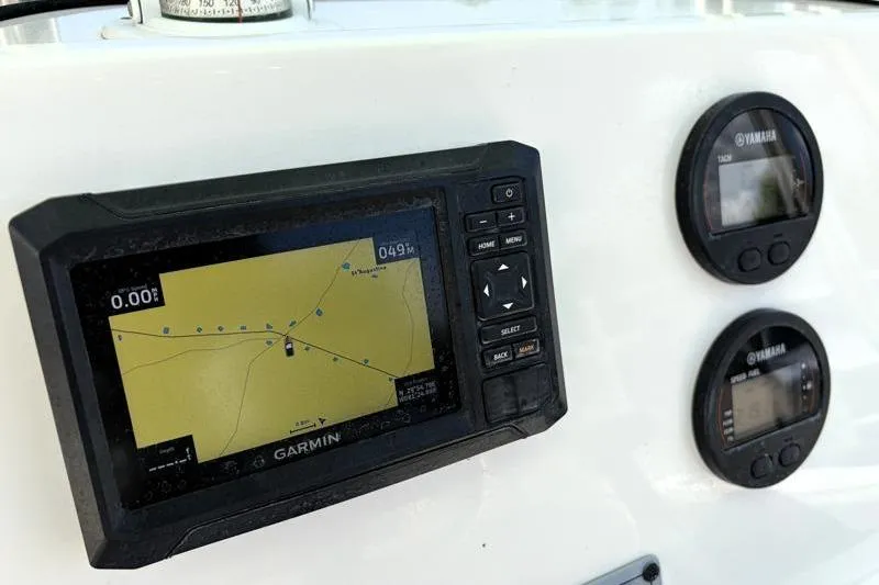 Slide: The Image of Garmin navigation system and Yamaha gauges on 2024 Key West 203 FS boat dashboard. - 30