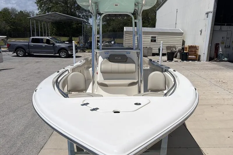 Slide: The Image of 2024 Key West 203 FS boat with seating, parked outdoors near a building. - 7