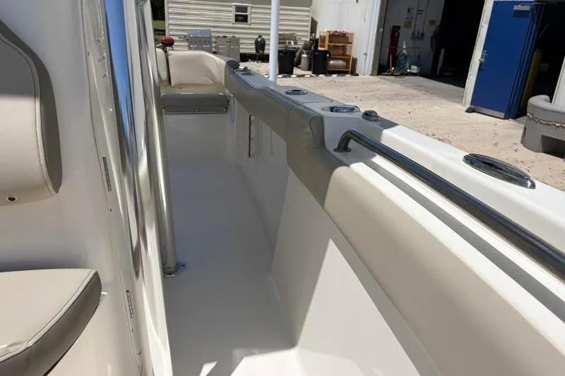 Slide: The Image of 2024 Key West 203 FS boat interior with beige seating and stainless steel railings. - 25