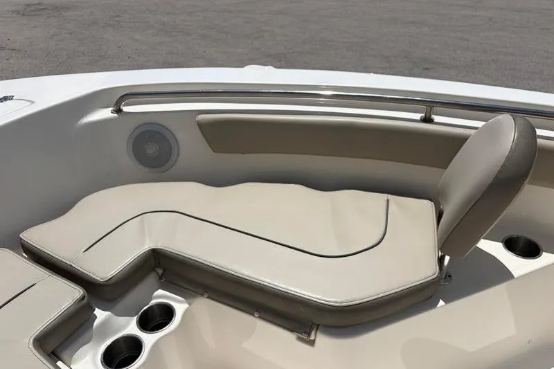 Slide: The Image of 2024 Key West 203 FS boat interior with cushioned seating and cup holders. - 19