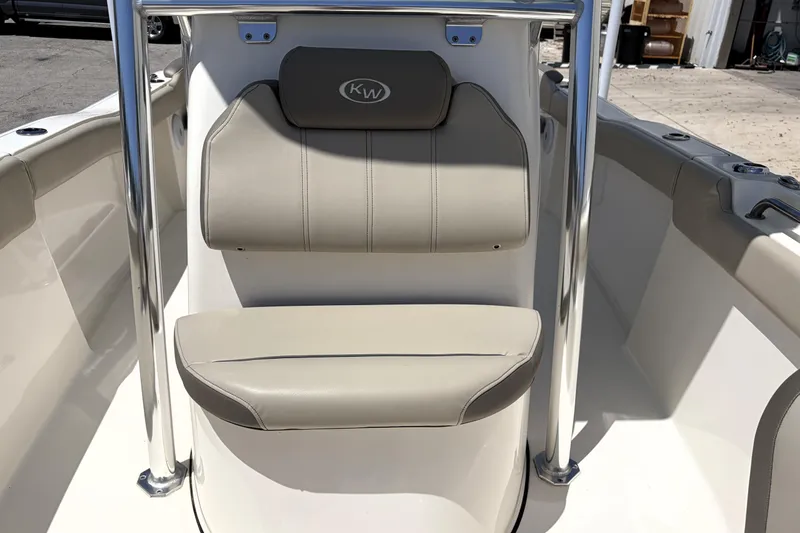 Slide: The Image of 2024 Key West 203 FS boat interior with beige seating and stainless steel frame. - 22