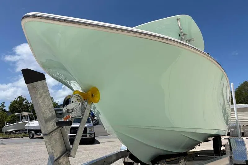 Slide: The Image of 2024 Key West 203 FS boat on trailer under clear blue sky. - 11