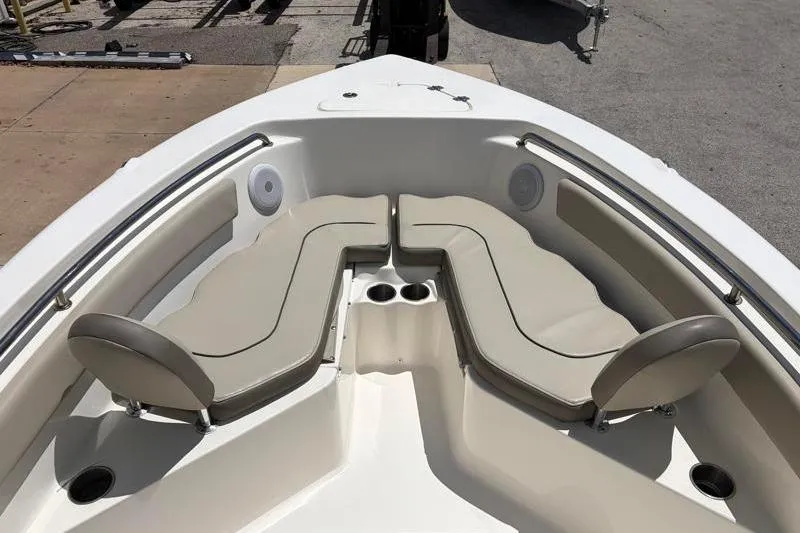 Slide: The Image of 2024 Key West 203 FS boat interior with cushioned seating and cup holders. - 18