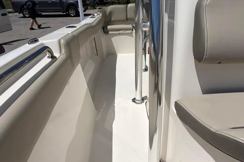 Slide: The Image of 2024 Key West 203 FS boat interior with beige seating and stainless steel railings. - 24