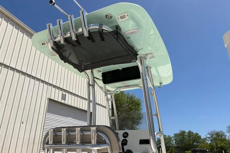 Slide: The Image of 2024 Key West 203 FS boat with T-top and rod holders under clear blue sky. - 16