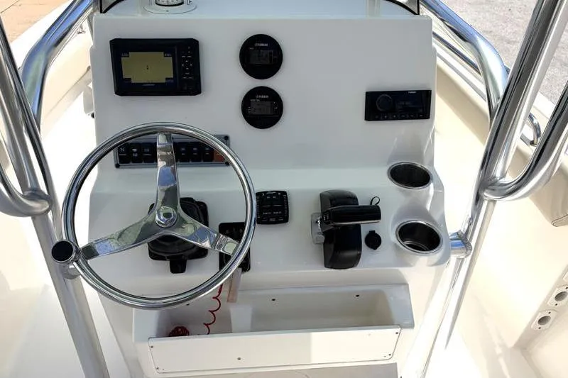 Slide: The Image of 2024 Key West 203 FS boat dashboard with steering wheel and control panel. - 27