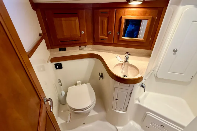 Slide: The Image of 2015 Tartan 4000 yacht bathroom with wooden cabinets and modern fixtures. - 19