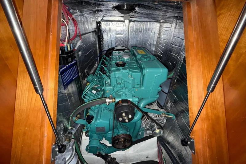 Slide: The Image of Engine compartment of a 2015 Tartan 4000 sailboat, featuring a green marine engine. - 21