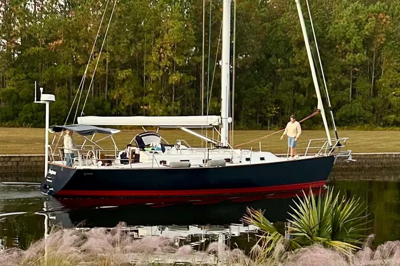 Slide: The Image of Sailboat Tartan 4000 (2015) on calm water with two people aboard. - 4
