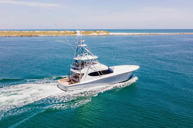 Slide: The Image of 2014 Hatteras 63 GT yacht cruising on open water. - 2