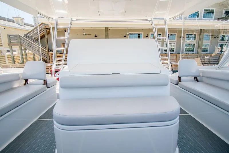 Slide: The Image of Interior of 2014 Hatteras 63 GT yacht, featuring sleek white seating and modern design. - 26