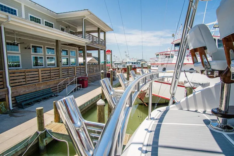 Slide: The Image of 2014 Hatteras 63 GT yacht docked at marina, sunny day, waterfront building. - 31