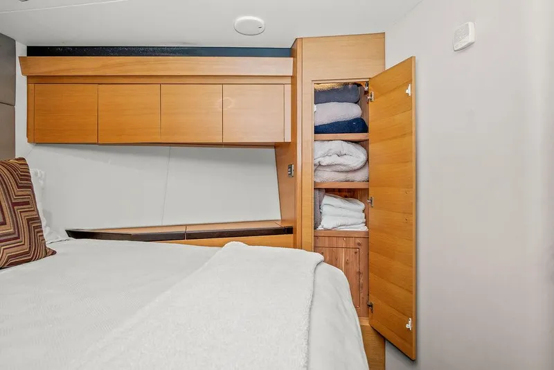 Slide: The Image of Interior of 2014 Hatteras 63 GT yacht with wooden cabinetry and open closet. - 35