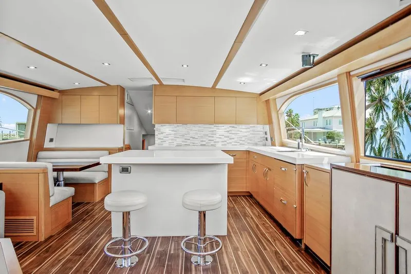 Slide: The Image of Luxurious interior of 2014 Hatteras 63 GT yacht with modern kitchen and seating area. - 36