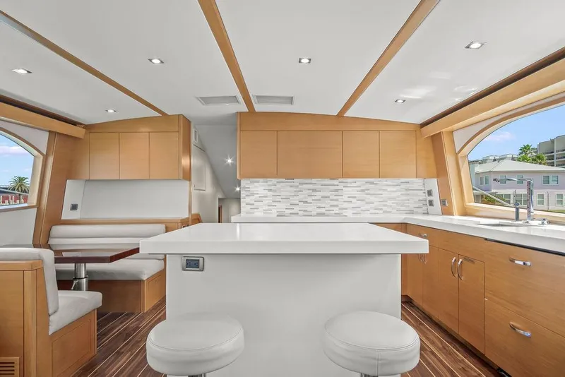 Slide: The Image of Luxurious interior of 2014 Hatteras 63 GT yacht with modern kitchen and seating area. - 40