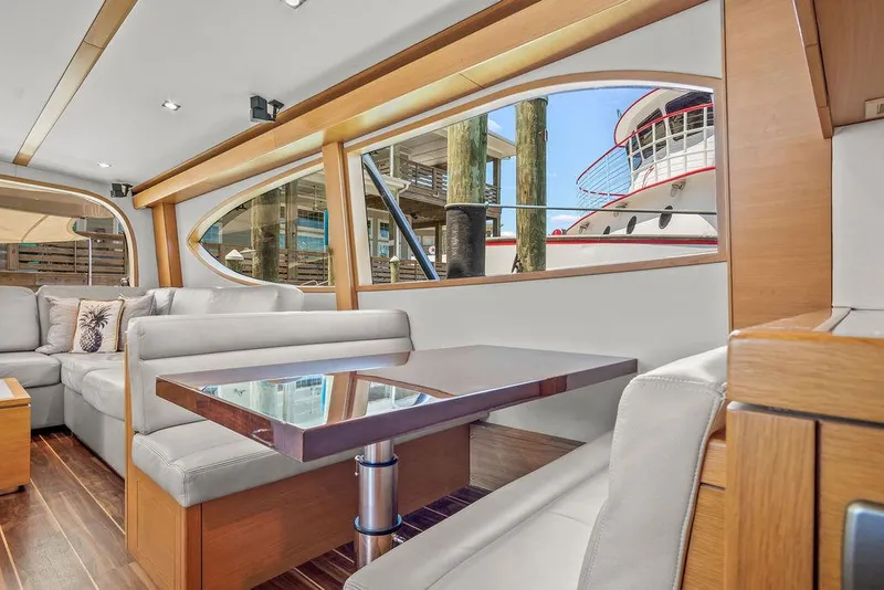 Slide: The Image of Luxurious interior of 2014 Hatteras 63 GT yacht with modern seating and large windows. - 45