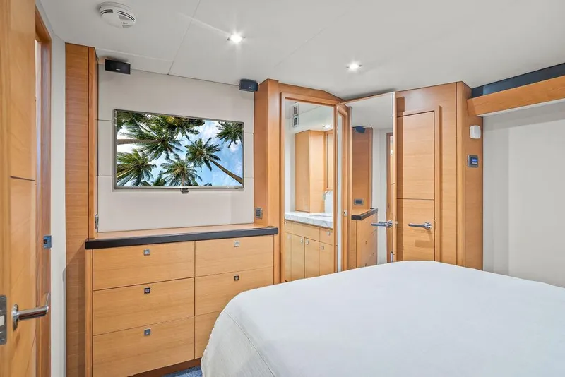 Slide: The Image of Luxurious bedroom interior of 2014 Hatteras 63 GT yacht with modern wood finishes. - 48