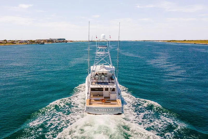 Slide: The Image of 2014 Hatteras 63 GT yacht cruising on open water. - 9
