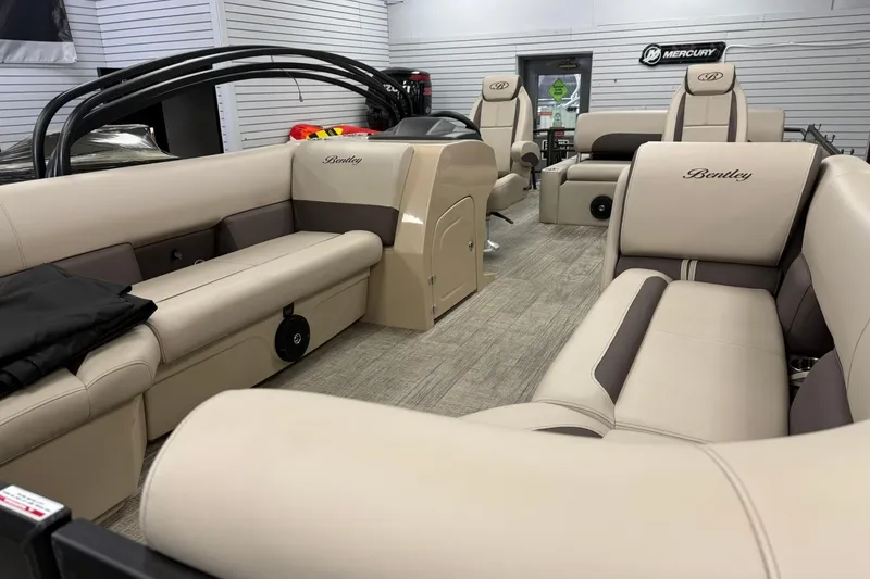 Slide: The Image of 2026 Bentley Pontoons Legacy 243 Swingback interior with luxurious beige seating and modern design. - 2
