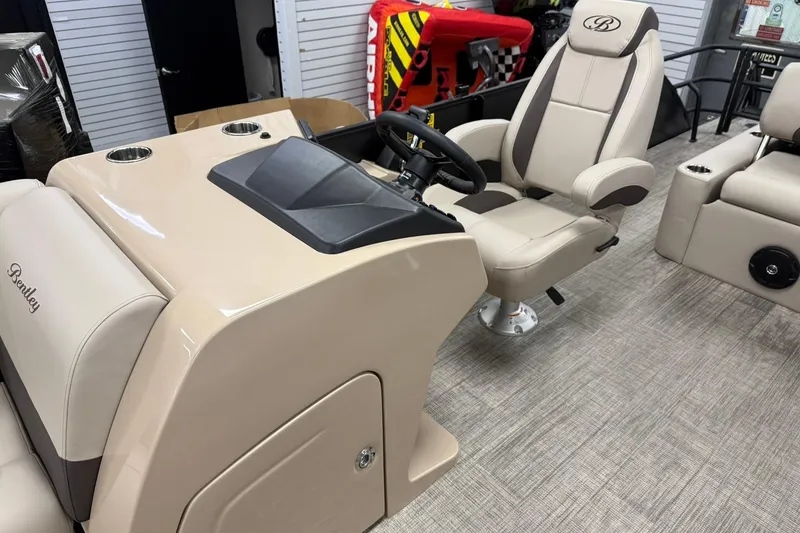 Slide: The Image of 2026 Bentley Pontoons Legacy 243 Swingback interior with beige captain's chair and console. - 3