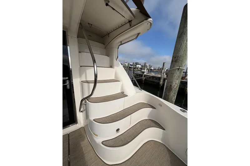 Slide: The Image of Staircase on 2001 Sea Ray 560 Sedan Bridge yacht, leading to upper deck. - 11