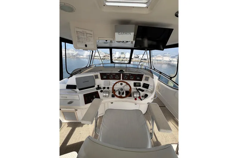 Slide: The Image of Interior helm of 2001 Sea Ray 560 Sedan Bridge with Garmin navigation system. - 13