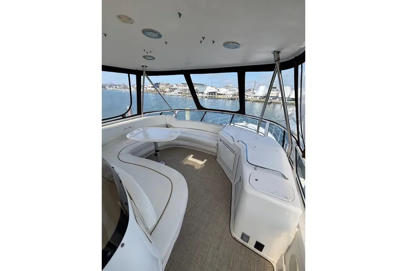 Slide: The Image of 2001 Sea Ray 560 Sedan Bridge interior with spacious seating and panoramic windows. - 15
