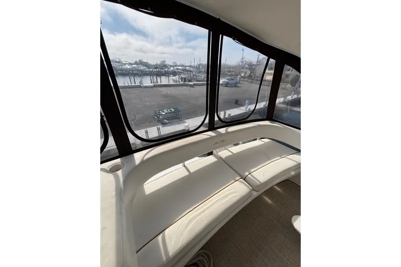 Slide: The Image of Interior view of 2001 Sea Ray 560 Sedan Bridge with marina backdrop. - 17