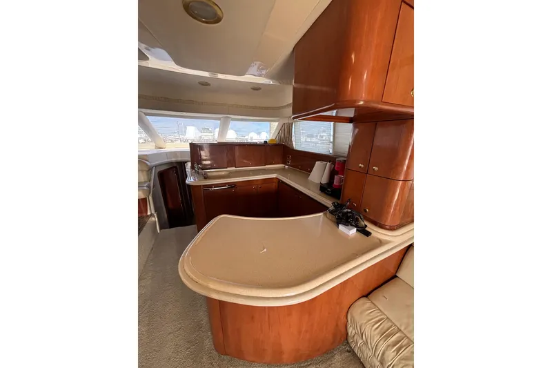 Slide: The Image of Luxurious interior of 2001 Sea Ray 560 Sedan Bridge yacht with elegant wood cabinetry. - 18