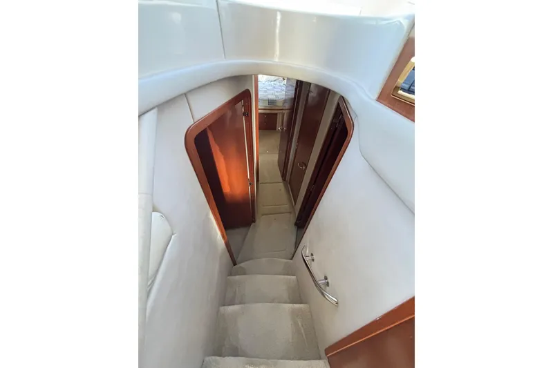 Slide: The Image of Stairway inside 2001 Sea Ray 560 Sedan Bridge yacht, featuring elegant wood accents. - 23