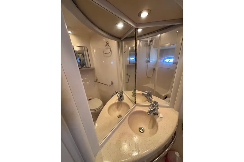 Slide: The Image of Luxurious bathroom in 2001 Sea Ray 560 Sedan Bridge yacht with mirrored vanity. - 28