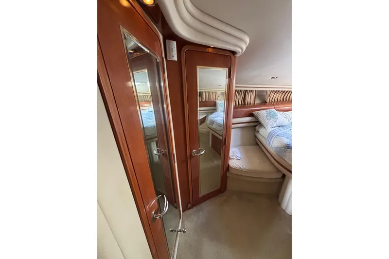 Slide: The Image of Luxurious cabin interior of 2001 Sea Ray 560 Sedan Bridge yacht with mirrored doors. - 31
