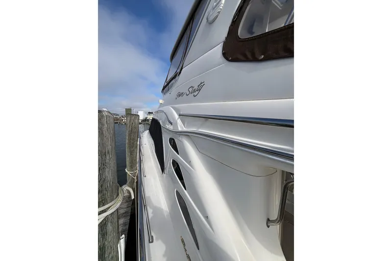 Slide: The Image of Side view of a 2001 Sea Ray 560 Sedan Bridge yacht docked at a marina. - 33