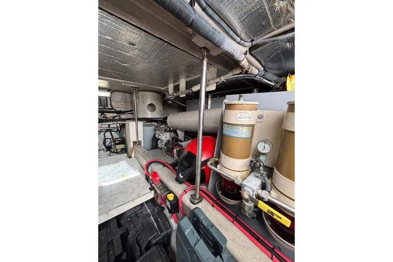 Slide: The Image of Engine room of 2001 Sea Ray 560 Sedan Bridge with visible fuel filters and piping. - 36