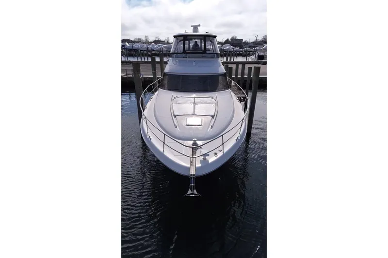 Slide: The Image of Front view of a 2001 Sea Ray 560 Sedan Bridge yacht docked in a marina. - 4
