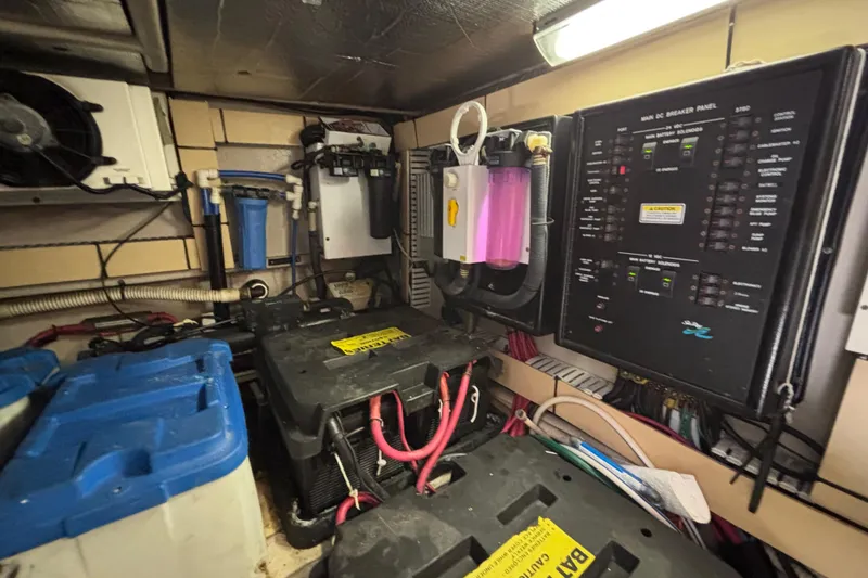 Slide: The Image of Engine room of 2001 Sea Ray 560 Sedan Bridge with electrical panel and battery setup. - 43