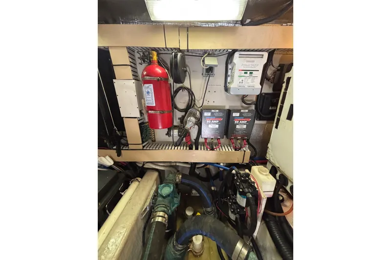 Slide: The Image of Engine room of 2001 Sea Ray 560 Sedan Bridge with fire extinguisher and electrical components. - 44