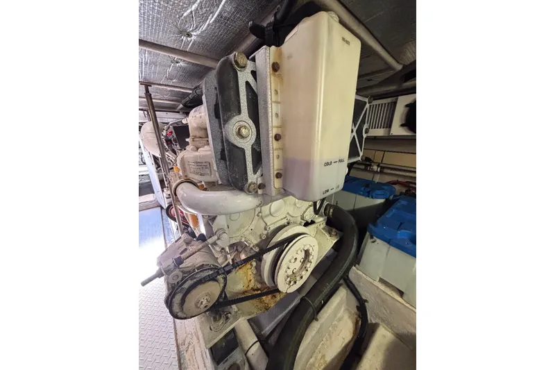 Slide: The Image of Engine compartment of a 2001 Sea Ray 560 Sedan Bridge yacht, showcasing mechanical components. - 46