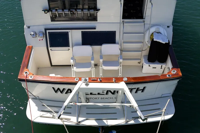 Slide: The Image of 1989 Californian 48 Cockpit Motor Yacht, rear view with seating and fishing equipment. - 13