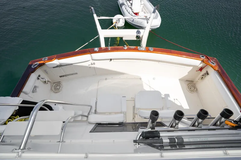 Slide: The Image of 1989 Californian 48 Cockpit Motor Yacht with spacious deck and fishing rod holders. - 17