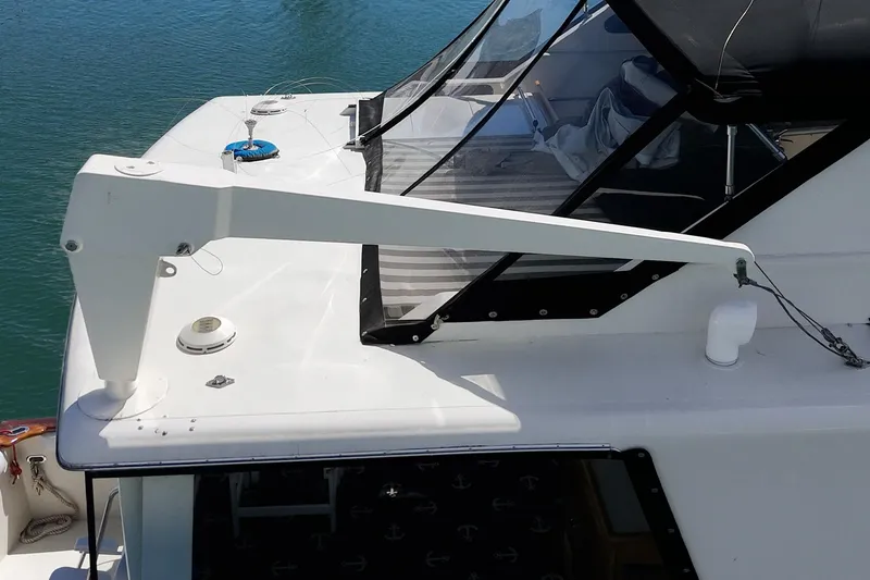 Slide: The Image of 1989 Californian 48 Cockpit Motor Yacht deck with davit arm and clear canopy. - 20
