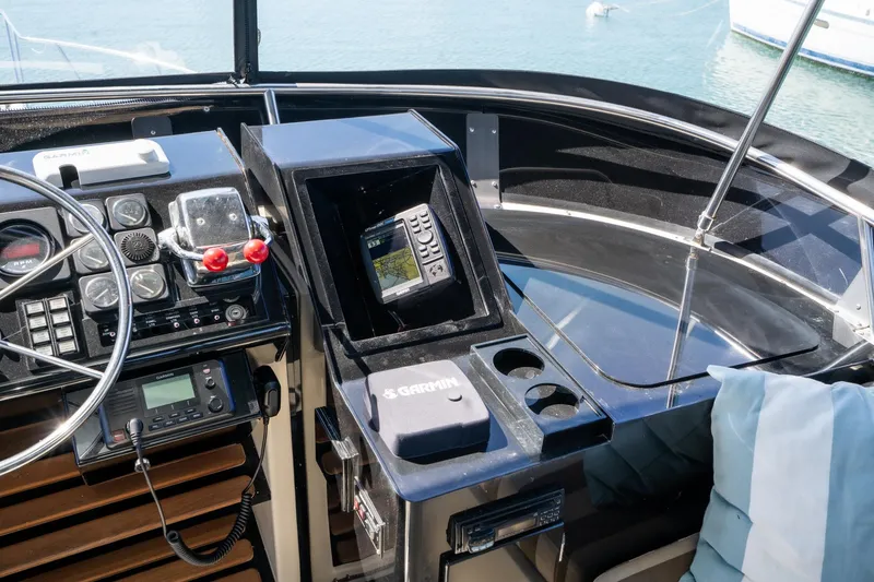 Slide: The Image of Cockpit of 1989 Californian 48 Motor Yacht with navigation equipment and steering wheel. - 26