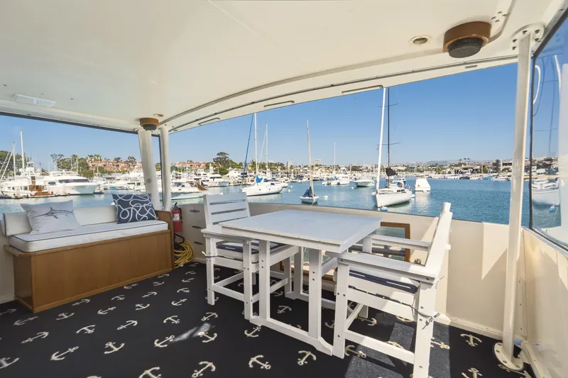 Slide: The Image of Californian 48 Cockpit Motor Yacht 1989, spacious deck with marina view, elegant seating. - 30