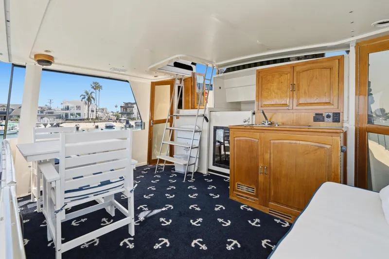 Slide: The Image of 1989 Californian 48 Cockpit Motor Yacht interior with nautical decor and wooden cabinetry. - 31