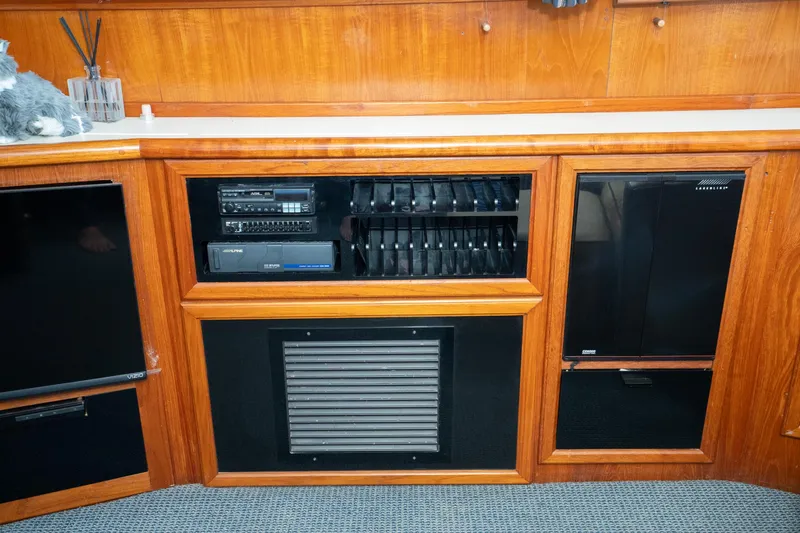 Slide: The Image of 1989 Californian 48 Cockpit Motor Yacht interior with wooden cabinetry and audio equipment. - 39