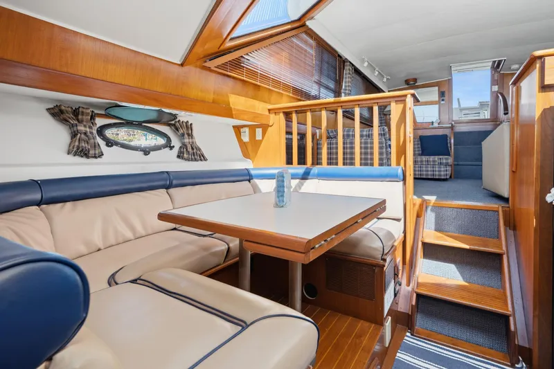 Slide: The Image of 1989 Californian 48 Cockpit Motor Yacht interior with cozy seating and wooden accents. - 44