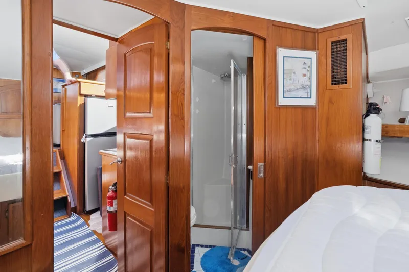 Slide: The Image of Interior of 1989 Californian 48 Cockpit Motor Yacht with wood paneling and compact bathroom. - 47