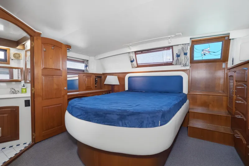 Slide: The Image of Luxurious cabin interior of 1989 Californian 48 Cockpit Motor Yacht with wooden finishes. - 49