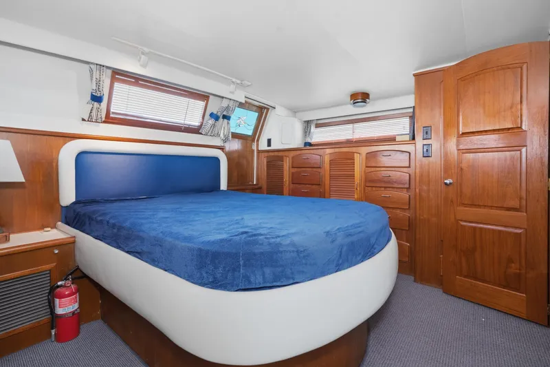Slide: The Image of Luxurious cabin interior of 1989 Californian 48 Cockpit Motor Yacht with blue bedding. - 50